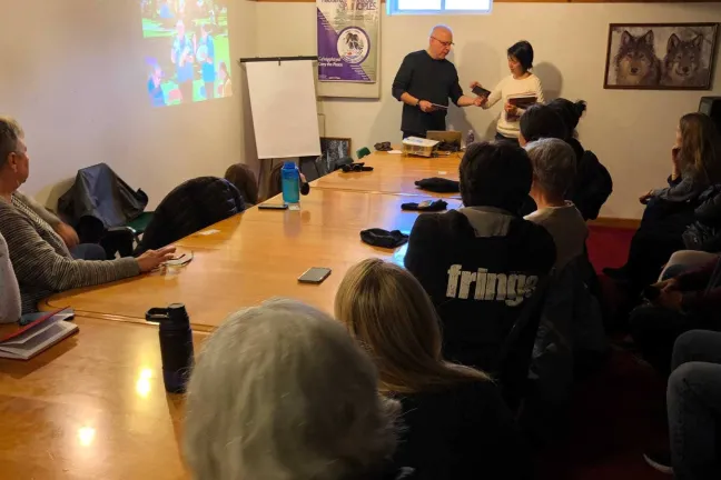A group of people sitting inside at a table.