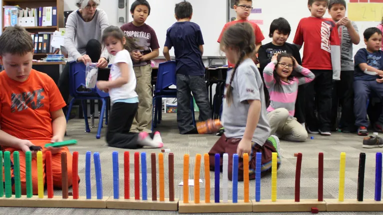 Multilink blocks in the foreground in rows. Students standing in the back.