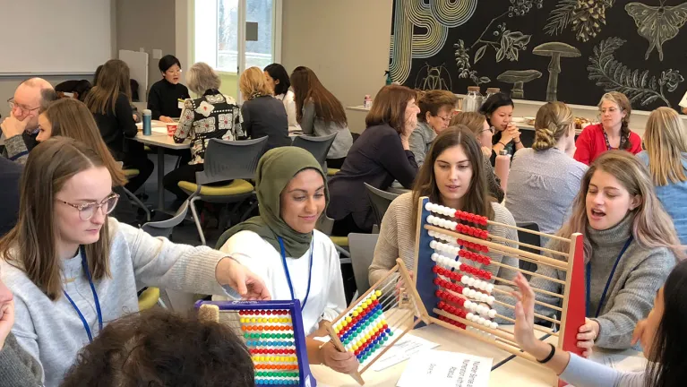 Photo of students in a university classroom at a mini conference featuring different approaches to math learning